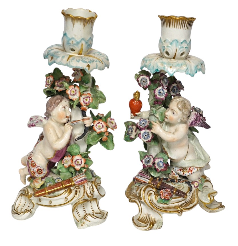 A pair of 19th century Derby porcelain candlesticks, with ‘winged cupid’ stems, 22cm. Condition - poor